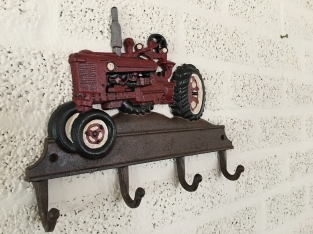 Farmhouse design coat rack with Farsnall agricultural tractor.